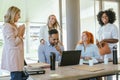 Multiethnic business colleagues smiling while enjoying time together at the office Royalty Free Stock Photo