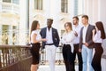 Multiethnic Business people having coffee break at the balcony of office building Royalty Free Stock Photo