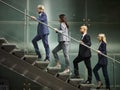 Multiethnic business people walking on steps in modern office Royalty Free Stock Photo