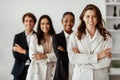 Multiethnic business team. Group of multicultural colleagues with female boss posing in office standing with folded arms Royalty Free Stock Photo