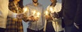 Multiethnic business team joining glowing light bulbs as metaphor for teamwork and sharing ideas Royalty Free Stock Photo