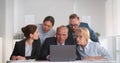 Multiethnic business team looking at laptop screen while working together in office Royalty Free Stock Photo