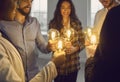 Team of happy business people standing in circle and holding shining vintage light bulbs Royalty Free Stock Photo