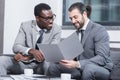 multiethnic businessmen smiling and reading document Royalty Free Stock Photo