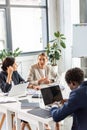 multiethnic businesspeople in formal wear at table during conference in office. Royalty Free Stock Photo