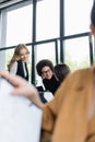 multiethnic businesswomen talking in office near