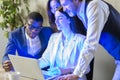 Multiethnic colleagues work together using pc. African mentor explains application aid to interns during group meeting. Coaching, Royalty Free Stock Photo