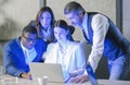 Multiethnic colleagues work together using pc. Business people working late at night in the office with blue lights in the Royalty Free Stock Photo