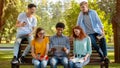 Multiethnic College Friends Relaxing After Classes Sitting On Bench Outdoors Royalty Free Stock Photo