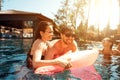 Multiethnic company of friends in swimming pool. Company of young people spend weekend in pool.