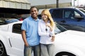 Multiethnic couple buying a new car Royalty Free Stock Photo