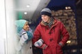 Multiethnic couple conversing at dusk during winter