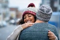 Multiethnic couple hugging outdoor in winter Royalty Free Stock Photo