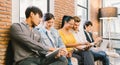 Multiethnic diverse group of young and adult people using smartphone, laptop computer, digital tablet together Royalty Free Stock Photo