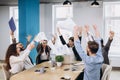 Multiethnic diverse happy team celebrate project success throw paper up together. Corporate community, college graduation, startup Royalty Free Stock Photo