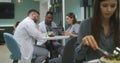 Multiethnic doctors sit in clinic cafe, use laptop Royalty Free Stock Photo