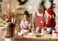 Multiethnic family, grandmother and three little kids, cooking Christmas cookies together in kitchen