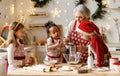 Multiethnic family, grandmother and three little kids, cooking Christmas cookies together in kitchen