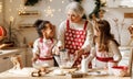 Multiethnic family, grandmother and two little kids, cooking Christmas cookies together in kitchen