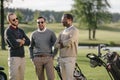 Multiethnic golfers spending time together in golf course Royalty Free Stock Photo