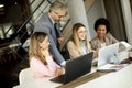 Multiethnic group of business people working together and preparing new project on a meeting in office Royalty Free Stock Photo