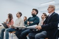 Multiethnic group of businesspeople engaged in a business seminar in modern office. Royalty Free Stock Photo