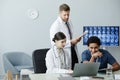 Multiethnic Group of Doctors Using Laptop And Looking at X-Ray Images Royalty Free Stock Photo