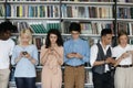 Multiethnic group of freshman students engaged in cellphone using