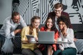 multiethnic group of friends lookign at laptop