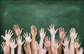 Multiethnic Group of Hands Raised with Blackboard Royalty Free Stock Photo