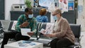 Multiethnic group of patients sitting in hospital reception to attend medical exam Royalty Free Stock Photo