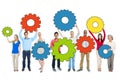 Multiethnic Group of People Holding Gears Royalty Free Stock Photo