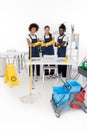 multiethnic group of professional cleaners in rubber gloves standing with crossed arms and looking