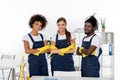 multiethnic group of professional cleaners in rubber gloves standing with crossed arms and smiling