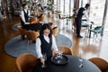 Multiethnic group of servers setting tables in restaurant preparing for guests Royalty Free Stock Photo