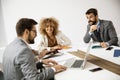 Multiethnic group of young business people working together and preparing new project on a meeting in office Royalty Free Stock Photo