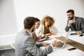 Multiethnic group of young business people working together and preparing new project on a meeting in office Royalty Free Stock Photo