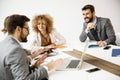 Multiethnic group of young business people working together and preparing new project on a meeting in office Royalty Free Stock Photo