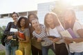 Multiethnic group of young cheerful students standing outdoors Royalty Free Stock Photo