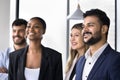 Multiethnic group of young happy business colleagues standing together Royalty Free Stock Photo