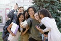 Multiethnic group of young happy students make selfie outdoors