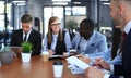 Multiethnic group of young people putting their hands on top of each other. Close up image of young business people