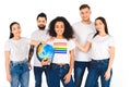 multiethnic group of young people touching shoulders of african american woman with lgbt sign on t-shirt holding globe isolated Royalty Free Stock Photo