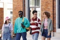 Multiethnic group of young students walking in row together and smiling Royalty Free Stock Photo