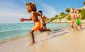 Multiethnic kids running on the beach in summer Royalty Free Stock Photo