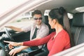 Multiethnic lover couple traveling together by car, using radio screen or GPS navigation system. Love or transportation technology Royalty Free Stock Photo