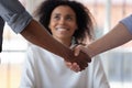 Multiethnic male partners handshake closing deal in office