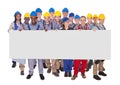 Multiethnic manual workers holding blank banner Royalty Free Stock Photo