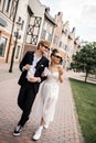 multiethnic newlyweds with french fries walking