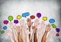 Multiethnic People's Hands Raised with Speech Bubbles Royalty Free Stock Photo